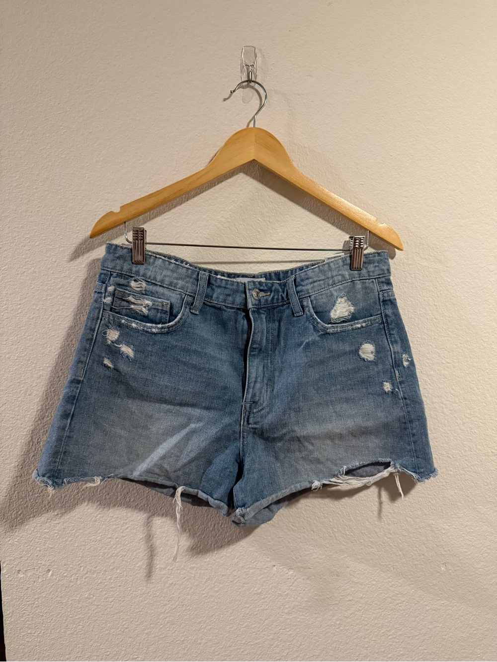 High-Rise Distressed Denim Shorts in Light Blue